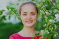 Portrait close up beautiful young woman in a spring blooming garden on a white flowers background Royalty Free Stock Photo