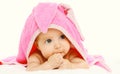 Portrait close-up cute baby under pink towel lying on bed isolated on white Royalty Free Stock Photo