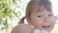 CLOSE UP, DOF: Lovely baby girl with cute pigtails plays with her toy doll. Royalty Free Stock Photo