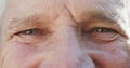 Portrait of close up of eyes of happy unaltered senior caucasian man, in slow motion