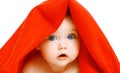 Portrait close-up of face cute baby under red towel on a white Royalty Free Stock Photo