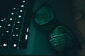 Portrait and close up of glasses on laptop with the light of screen with green binary numbers Royalty Free Stock Photo