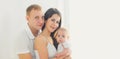 Portrait close up of happy family, mother and father with baby home in white room Royalty Free Stock Photo