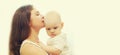 Portrait close up of happy mother kissing her cute baby over a w Royalty Free Stock Photo