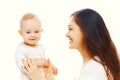 Portrait close-up happy smiling mother playing with her cute baby isolated on white Royalty Free Stock Photo