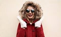 Portrait close up happy smiling surprised young woman wearing white mittens, red jacket with fur hood Royalty Free Stock Photo
