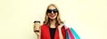 Portrait close up happy smiling young woman with colorful shopping bags and coffee cup wearing a red business blazer on Royalty Free Stock Photo