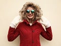 Portrait close up happy smiling young woman having fun wearing white mittens, red jacket with fur hood Royalty Free Stock Photo