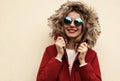 Portrait close up happy smiling young woman wearing red jacket with fur hood Royalty Free Stock Photo