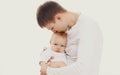 Portrait close up of happy young father kissing his baby isolated on white background Royalty Free Stock Photo