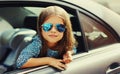 Portrait close up of little girl child sitting in car as passenger looking out of car window Royalty Free Stock Photo