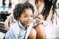 Portrait close up of little guy enjoying time outdor with his mommy. Family with black mother and son in outdoors leisure activity Royalty Free Stock Photo