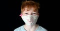 Portrait close up of little red hair boy wearing face mask during coronavirus pandemic blue eyes aryan