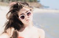 Portrait close up of a pretty teenage girl with long hair and sunglasses Royalty Free Stock Photo