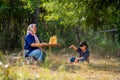 Portrait and close up of Senior Asian woman work with winnow rice using basketry and little girl stay beside and also work with