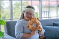 Portrait close up shot of Asian young happy chubby down syndrome autistic autism girl model wearing eyeglasses white knitted