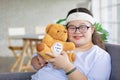 Portrait close up shot of Asian young happy chubby down syndrome autistic autism girl model wearing eyeglasses white knitted Royalty Free Stock Photo