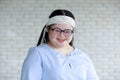 Portrait close up shot of Asian young happy chubby down syndrome autistic autism girl model wearing white knitted headband