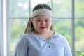 Portrait close up shot of Asian young happy chubby down syndrome autistic autism girl model wearing white knitted headband