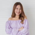 Portrait close up shot of young pretty asian female with long brown hair wearing light purple long sleeve shirt stand smiling to Royalty Free Stock Photo