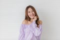 Portrait close up shot of young pretty asian female with long brown hair wearing light purple long sleeve shirt stand smiling to Royalty Free Stock Photo