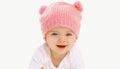 Portrait close up of sweet baby wearing knitted pink hat over a white background Royalty Free Stock Photo