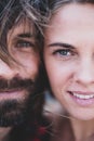 Portrait and close up of two bbeautiful and handsome adults smiling and looking at the camera - woman with blue eyes and man with