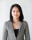 Portrait close-up of young Asian businesswoman over white background