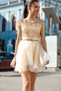 Portrait close up of young beautiful brunette woman in a beige dress Royalty Free Stock Photo