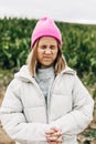 Portrait with closed eyes of a funny and cute teenage girl on a background of a green field with corn Royalty Free Stock Photo