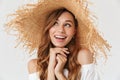 Portrait closeup of adorable woman 20s wearing big straw hat posing on camera with lovely smile, isolated over white background, Royalty Free Stock Photo