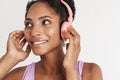 Portrait of african american pleased woman using headphones and smiling Royalty Free Stock Photo