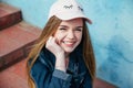 Portrait closeup beautiful young girl in city. Smiling girl in hat Royalty Free Stock Photo