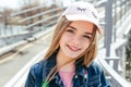 Portrait closeup beautiful young girl in city. Smiling girl in hat Royalty Free Stock Photo