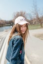 Portrait closeup beautiful young girl in city. Smiling girl in hat Royalty Free Stock Photo