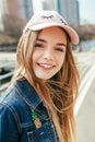 Portrait closeup beautiful young girl in pink hat in city street Royalty Free Stock Photo