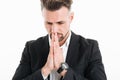 Portrait closeup of serious concentrated man wearing black jacket putting palms together for praying, isolated over white Royalty Free Stock Photo