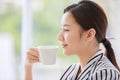 Portrait closeup shot of Asian young pretty beautiful successful friendly female businesswoman face wears black and white stripe Royalty Free Stock Photo