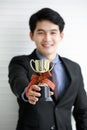 Portrait closeup shot of Asian young successful male entrepreneur wears black formal suit necktie and gray shirt win competition Royalty Free Stock Photo