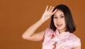 Portrait closeup studio shot millennial Asian female model in pink Chinese cheongsam qipao traditional peacock & flowers pattern Royalty Free Stock Photo