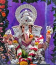 Portrait , closeup view of decorated and garlanded idol of Hindu God Ganesha in Pune, India