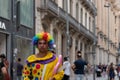 Portrait of a clown on the street, he looks angry down the street