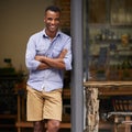 Portrait, coffee shop and black man as small business owner at front door with a smile. Entrepreneur person as barista