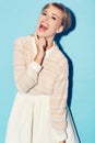 Portrait, comic and comedy with a woman in studio on a blue background for fun or laughter. Fashion, laugh and humor
