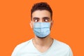 Portrait of comic crazy positive brunette man with surgical medical mask looking cross-eyed, having fun with silly face expression Royalty Free Stock Photo