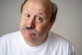 Portrait of comic and crazy senior man with funny face Royalty Free Stock Photo