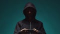 Portrait of computer hacker in hoodie. Obscured dark face. Data thief, internet fraud, darknet and cyber security . Royalty Free Stock Photo