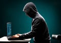 Computer hacker in white mask and hoodie. Obscured dark face. Data thief, internet fraud, darknet and cyber security Royalty Free Stock Photo