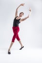 Portrait of Concentrated Contemporary Ballet Dancer Flexible Athletic Man Posing in Red Tights in Ballanced Dance Pose With Hands