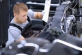 Concentrated male mechanic work with tool, fix damaged motorbike at workshop Royalty Free Stock Photo